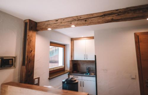 a small kitchen with a counter and a window at SennHOF Lechtal in Bach