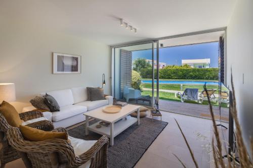 a living room with a couch and a table at Blue Villa H - Sagres - 10 min walk to the beach in Sagres
