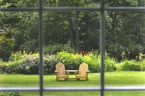 two chairs sitting around a table in the grass at Buttonwood Inn on Mount Surprise in North Conway