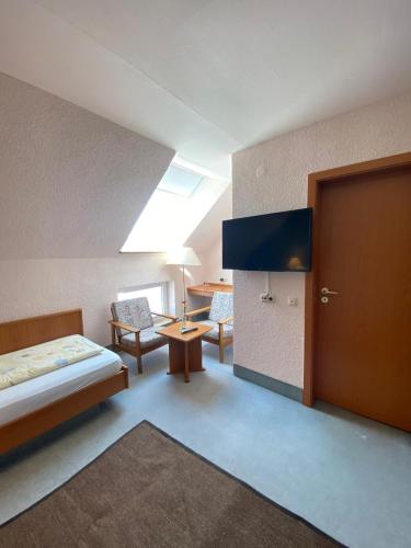 a room with a bedroom with a bed and a door at Hotel Weller in Riedstadt