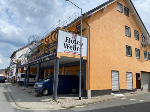 a hotel walkership sign in front of a building at Hotel Weller in Riedstadt