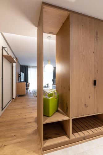 a large wooden cabinet with a green object in a room at Sackmann Genuss und Spa Resort in Baiersbronn