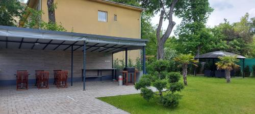a patio with chairs and a table next to a building at Anna Villa Füred Boutique Rooms in Balatonfüred
