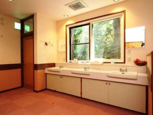 a bathroom with two sinks and a window at Oyado Fubuki - Vacation STAY 45512v in Nozawa Onsen