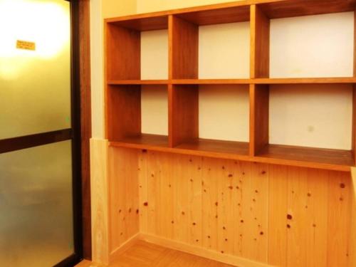 a room with wooden shelves on a wall at Oyado Fubuki - Vacation STAY 45512v in Nozawa Onsen
