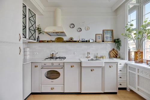 a kitchen with a washing machine and a sink at Dom & House - Old Town Swietego Ducha in Gdańsk