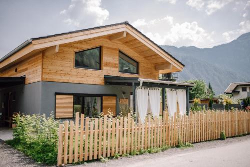 a house with a wooden fence in front of it at Haus Wildmoos in Sankt Martin bei Lofer