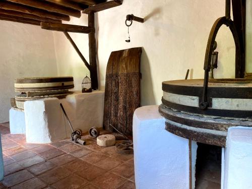 a room with a table and a large wine barrel at Casa Rural Molino de Bony in Júzcar
