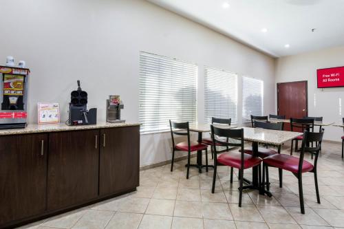 a restaurant with a table and chairs in a room at Red Roof Inn Carrollton in Carrollton
