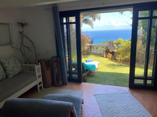 a living room with a view of the ocean at Casa Doro Villa in Glacis