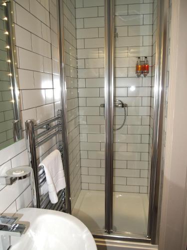 a bathroom with a shower and a sink at York House Hotel in Wakefield