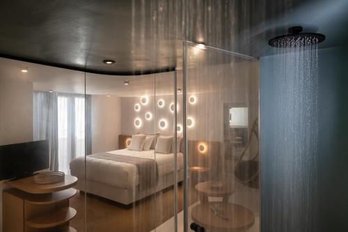 a bedroom with a bed and a glass wall at Argo Boutique Hotel in Naxos Chora