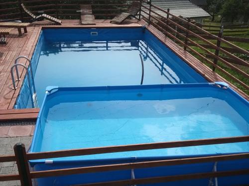 a large blue swimming pool on top of a house at Забаганка in Mykulychyn