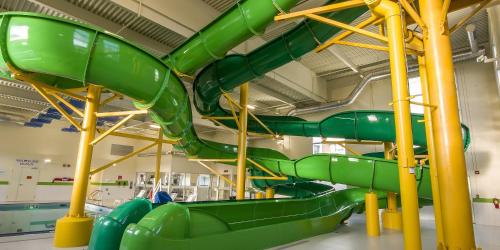 a green slide in a room with a water park at Holiday Inn St Johns by IHG in St. John's