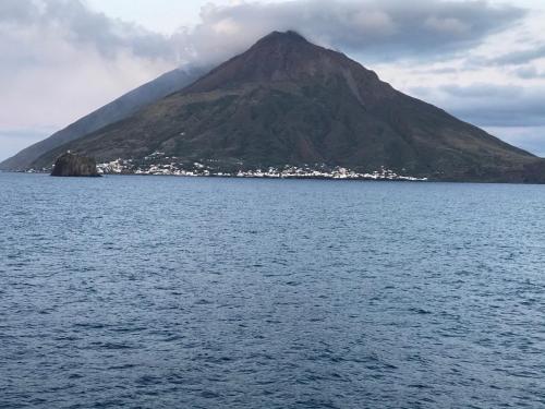 a mountain in the middle of a body of water at A' Riggiola in Stromboli