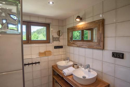 a bathroom with two sinks and a shower at U Justina na potůčku in Velké Karlovice