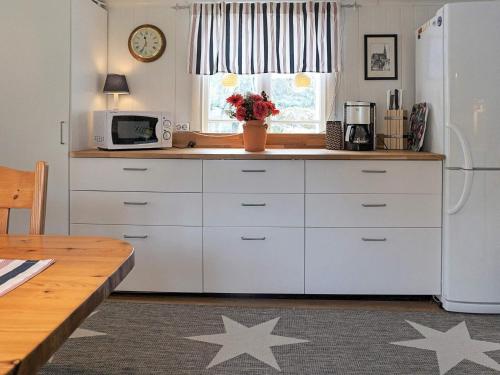 a kitchen with white cabinets and stars on the floor at 4 person holiday home in LYSEKIL-By Traum in Lysekil
