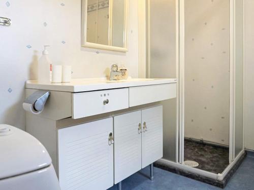 a white bathroom with a sink and a mirror at 4 person holiday home in LYSEKIL-By Traum in Lysekil