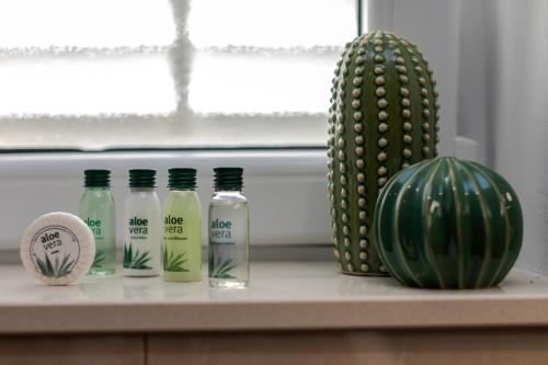 a counter with three bottles of water and a cactus at Luxury Apartman Tinel in Mimice