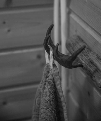 a pair of towels hanging on a door at Davvi Siida - Reindeer Design Lodge in Kjøllefjord