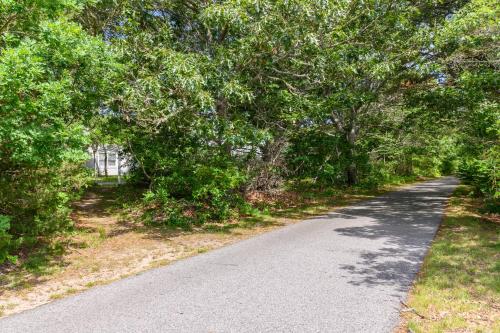 a winding road with trees on both sides at Captains Quarters Motel & Conference Center in Eastham