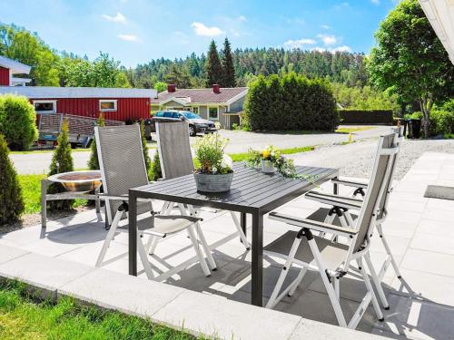 a wooden table and chairs on a patio at 5 person holiday home in K LLEK RR in Spjärr