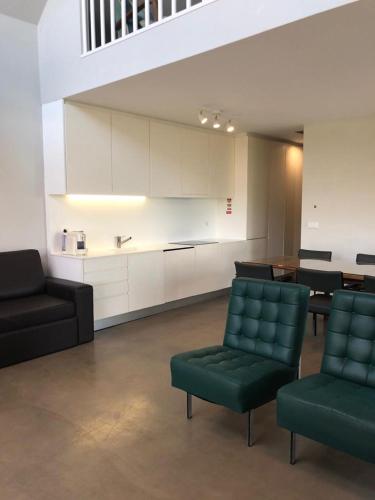 a living room with a couch and chairs and a table at Casa do Eido dos Calhões in Ponte de Lima