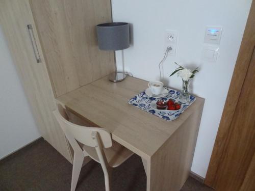 a wooden desk with a chair and a lamp at DOMUS MARIAE Gietrzwałd in Gietrzwałd