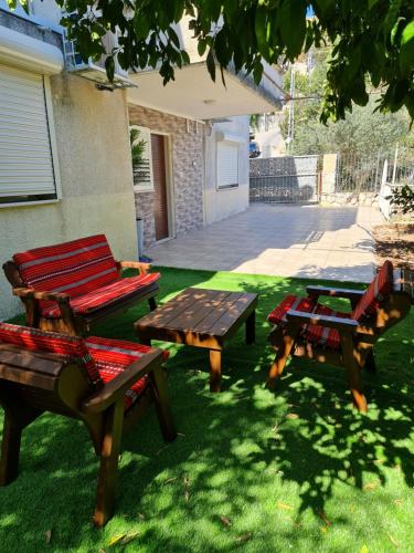 a group of picnic tables sitting in the grass at SAMA Tarshiha in Ma'alot Tarshiha