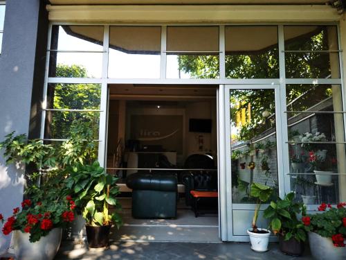 a sliding glass door of a house with potted plants at LIRA EXCELLENT NIS in Niš