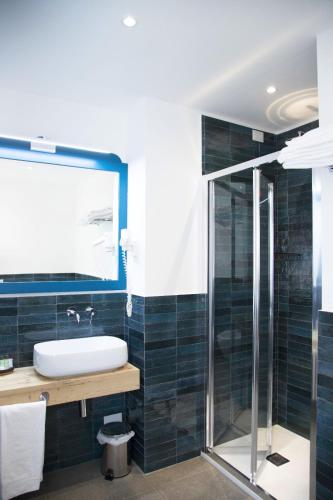 a bathroom with a sink and a shower at Isolotto Guest House in Porto Ercole