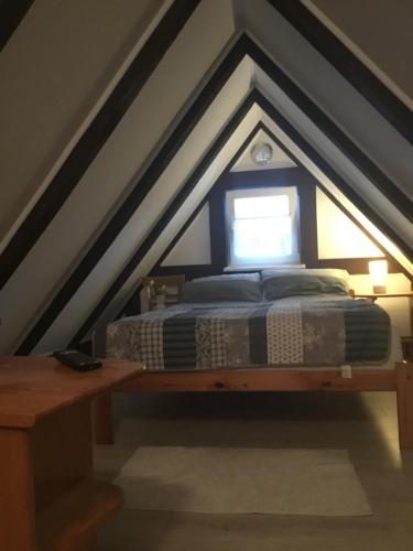 a bedroom with a bed in the attic at Domek Kasi in Ustka