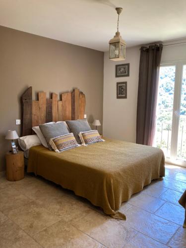 a bedroom with a large bed and a large window at Chambre U Bugnu in Vico