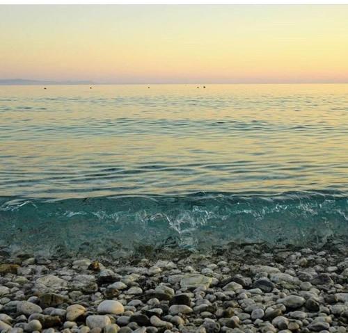 a rocky beach with the ocean in the background at Villa Praljan in Borsh