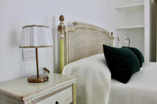 a bedroom with a bed and a table with a lamp at Cetara Costa d'Amalfi Residence in Cetara
