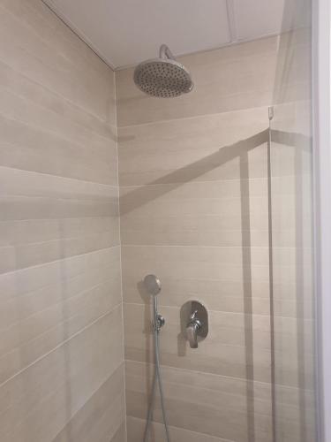 a shower with a shower head in a bathroom at Sunset Waves Benidorm by KalmaRent in Benidorm