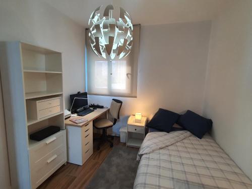 a small bedroom with a bed and a desk and a desk at Sunset Waves Benidorm by KalmaRent in Benidorm