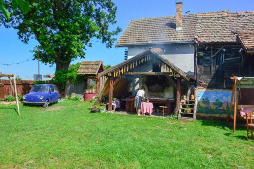 a man standing in front of a house at Salaš Isailovi in Sremska Mitrovica