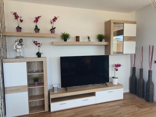 a living room with a flat screen tv on a entertainment center at Sunset Waves Benidorm by KalmaRent in Benidorm