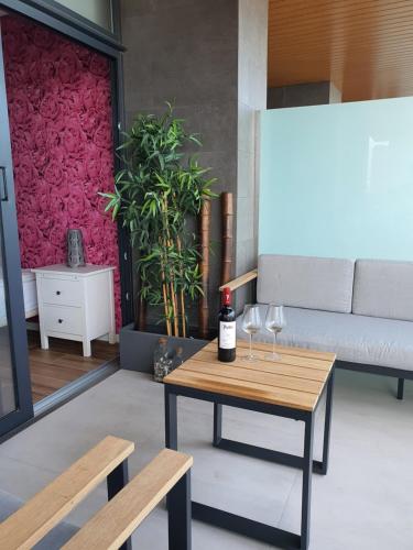 a living room with a table and wine glasses at Sunset Waves Benidorm by KalmaRent in Benidorm