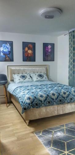 a bedroom with a bed with a blue comforter at Passion by Nights & Smiles in Tuzla