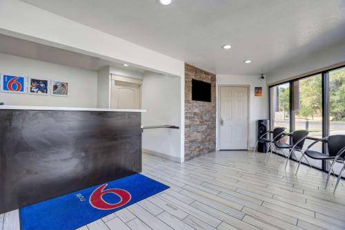 a room with a gym with a counter and chairs at Motel 6-Anderson, CA - Redding Airport in Anderson