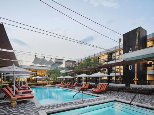a pool at a hotel with chairs and umbrellas at RISE Uptown in Phoenix