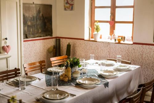 a table with a white table cloth and plates on it at Salaš Isailovi in Sremska Mitrovica