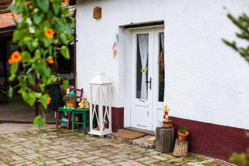 a white house with a door and a table at Salaš Isailovi in Sremska Mitrovica