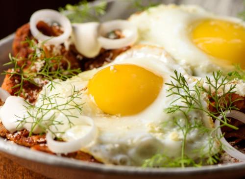 a plate of eggs on top of some food at Diez Diez Collection in Mérida