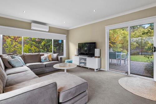 a living room with a couch and a tv at Jack's House B&B Clare in Clare