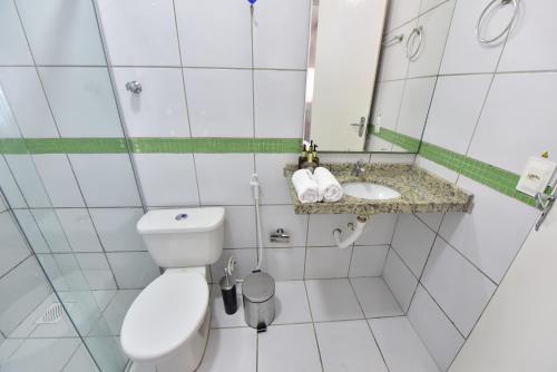 a small bathroom with a toilet and a sink at LIVE IN FORTALEZA HOTEL in Fortaleza