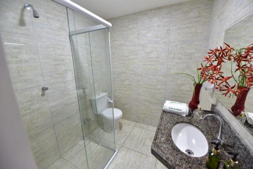 a bathroom with a shower and a toilet and a sink at LIVE IN FORTALEZA HOTEL in Fortaleza