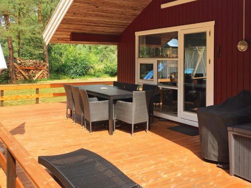 a patio with a table and chairs on a deck at 8 person holiday home in Nex in Vester Sømarken